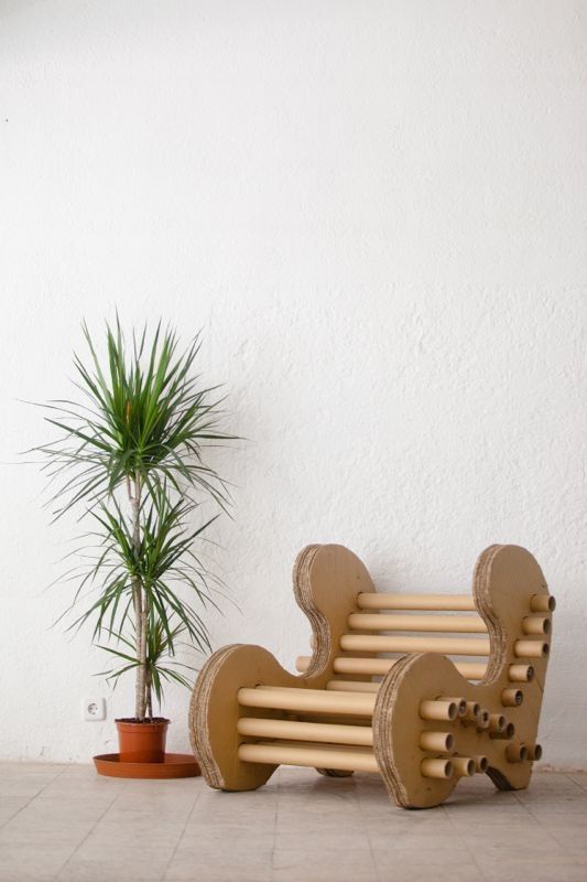 a wooden bench sitting next to a potted plant