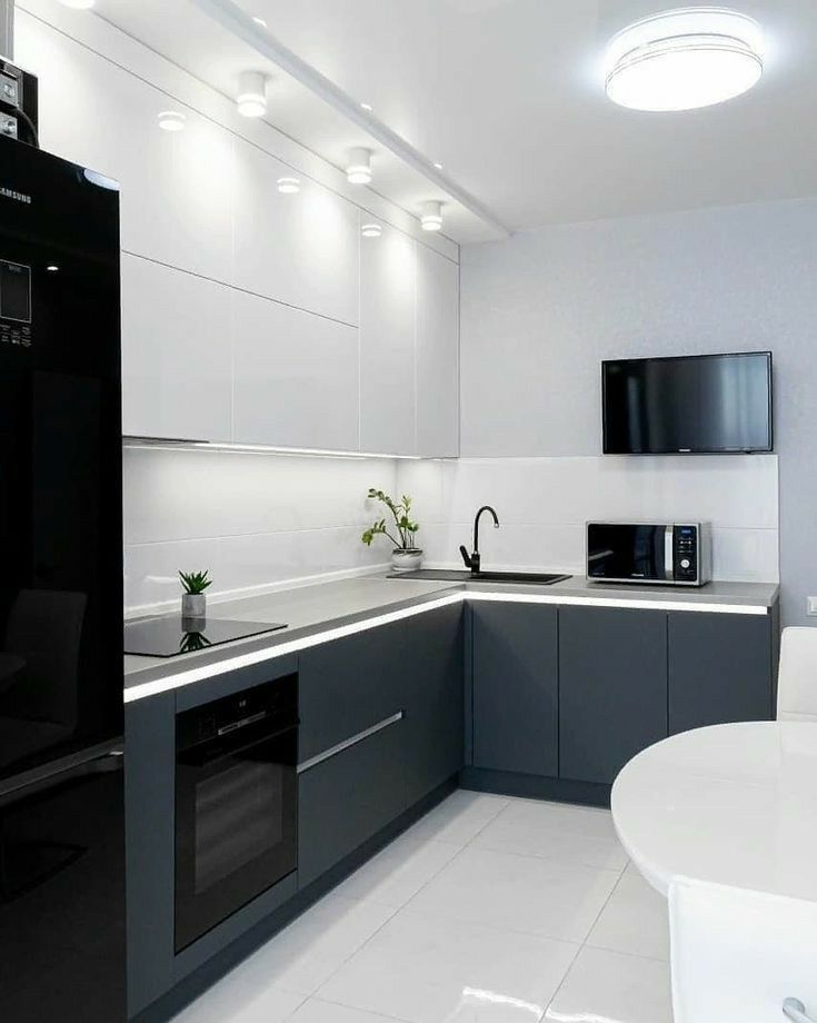 a modern kitchen with black and white appliances