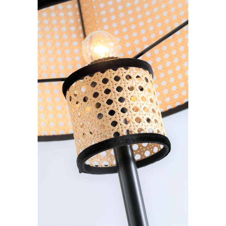 a black and white lamp with polka dot lampshade on the ceiling above it