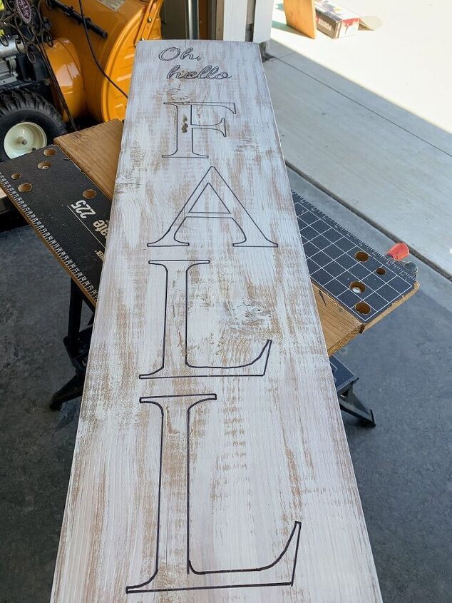 a long piece of wood that has some writing on it