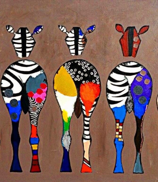 four zebras are standing in a row with numbers painted on them