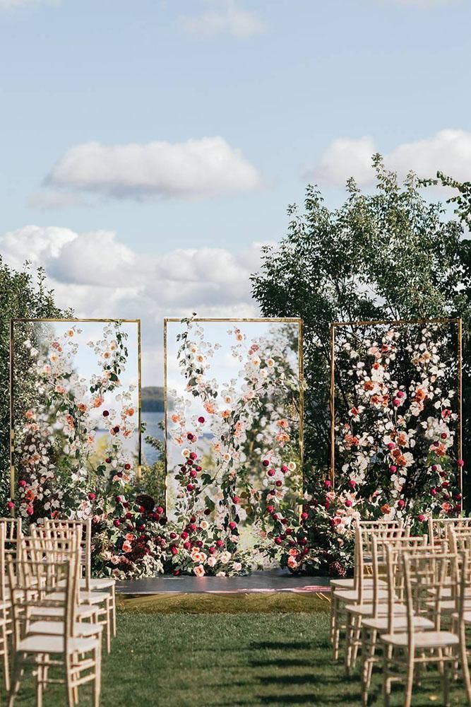 an outdoor ceremony setup with chairs and flowers