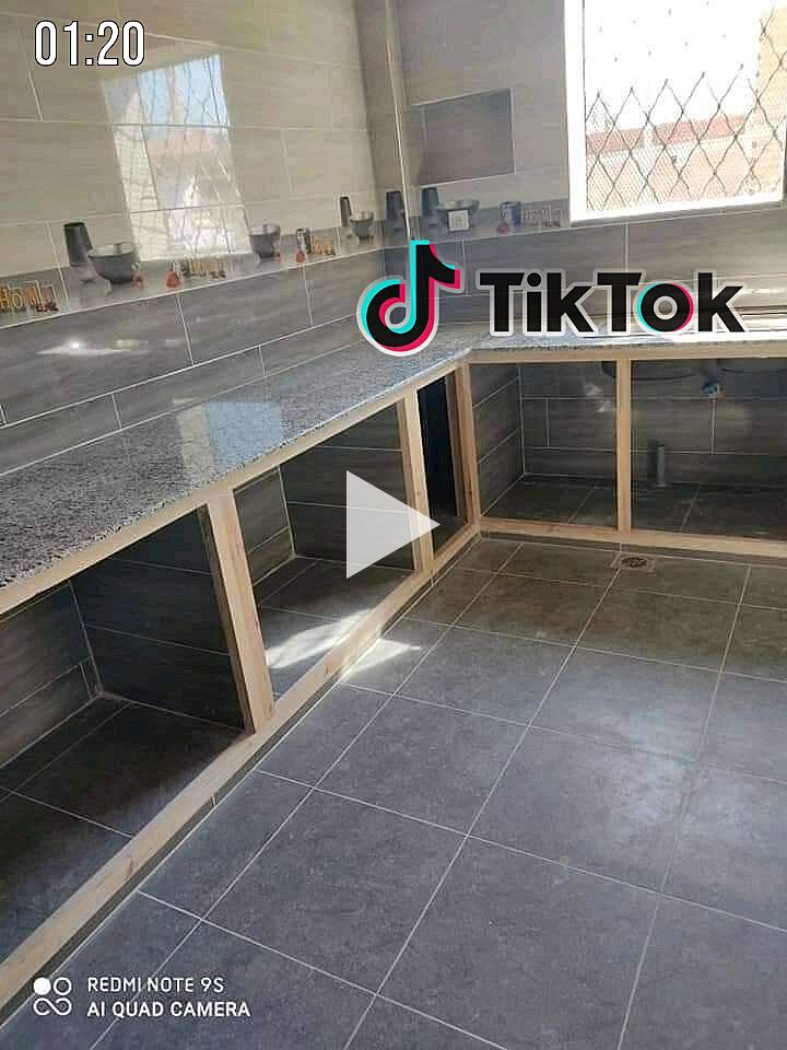 an empty kitchen with tile flooring and counter tops in the middle of the room