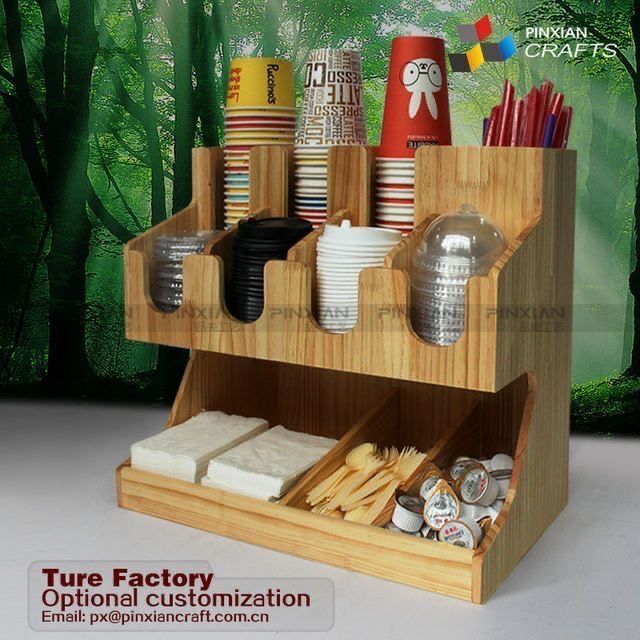 a wooden holder with cups and other items in it