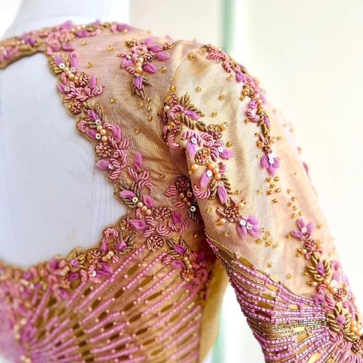 a pink and gold dress on a mannequin's headdress with beading