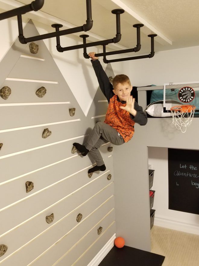 a young boy is playing basketball on the wall in his room with black and white walls