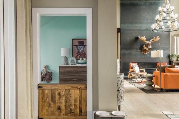 an open door leading to a living room with furniture and decor on the walls in front of it