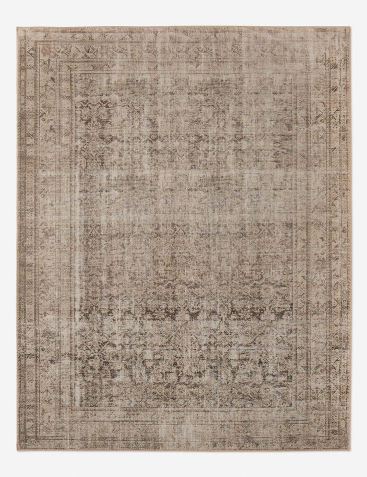 an antique style rug in beige and brown tones with a faded design on the middle