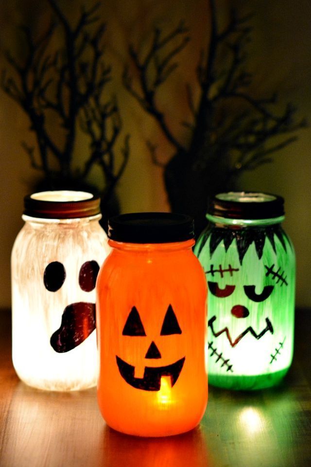 three mason jars decorated with halloween pumpkins and jack - o'- lantern faces