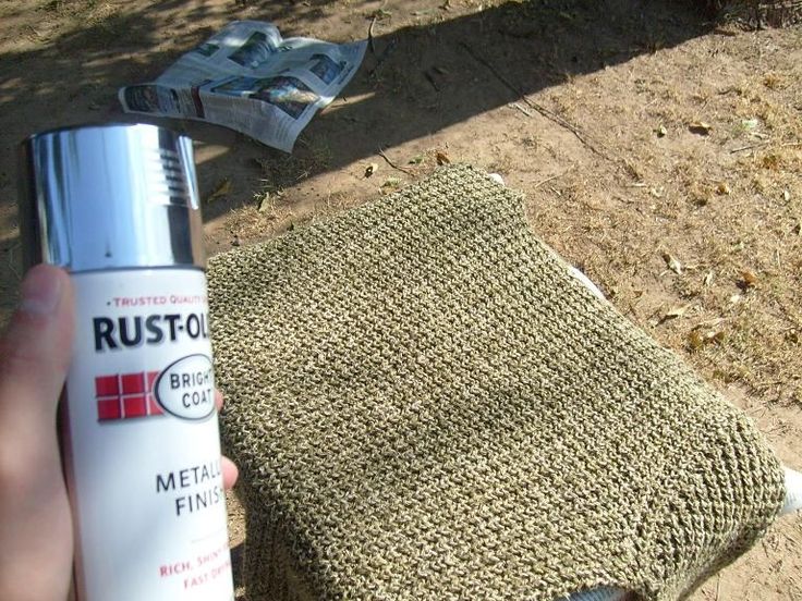 a person holding a tube of rusto next to a cloth