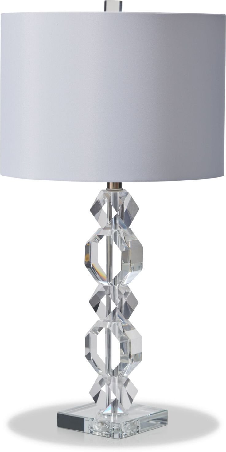 a crystal table lamp with a white shade on the base and a silver lampshade