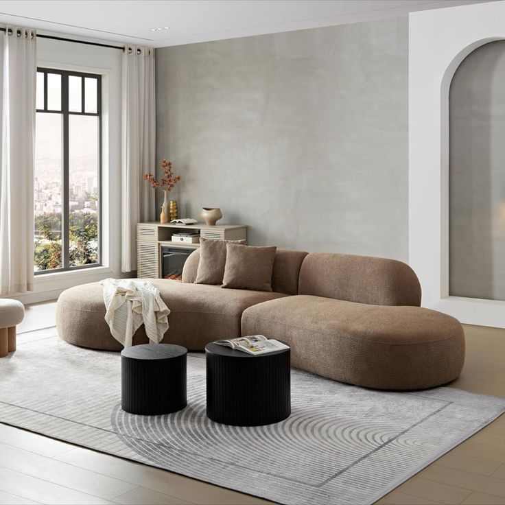 a modern living room with large windows and beige furniture in the center, along with an area rug on the floor