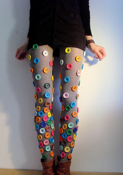 a woman standing on top of a wooden floor wearing tights with buttons all over them