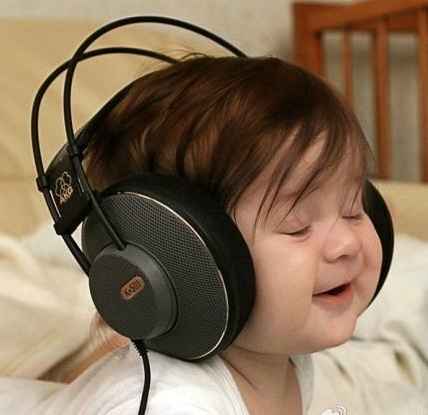 a young child wearing headphones while laying in bed