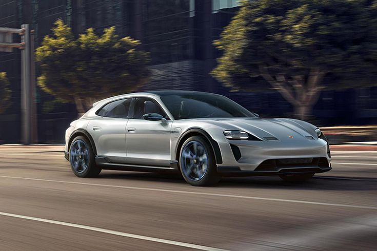 a silver electric car driving down the street