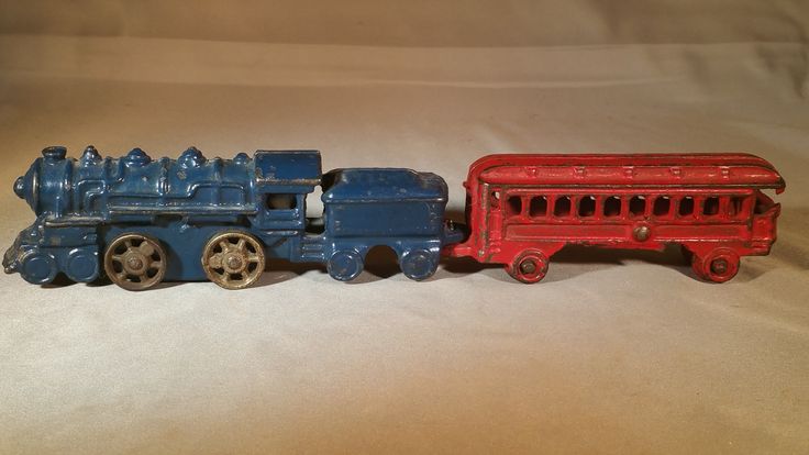 an old fashioned toy train is painted red and blue