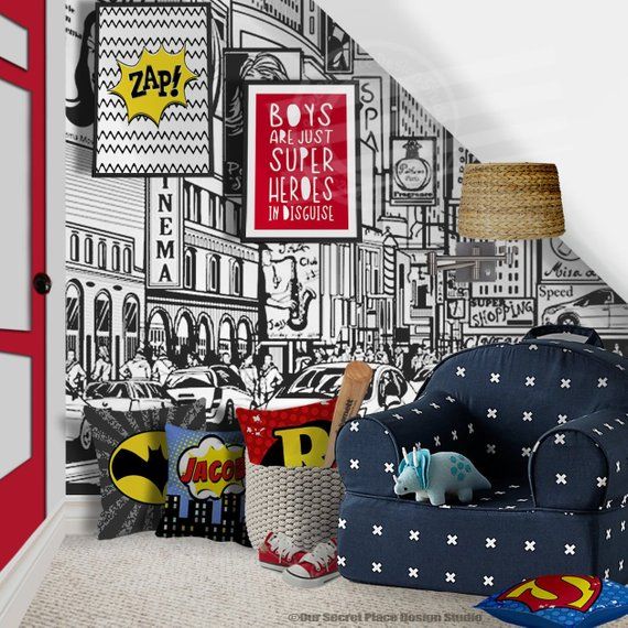 a kid's room decorated in black, white and red with superhero wallpaper