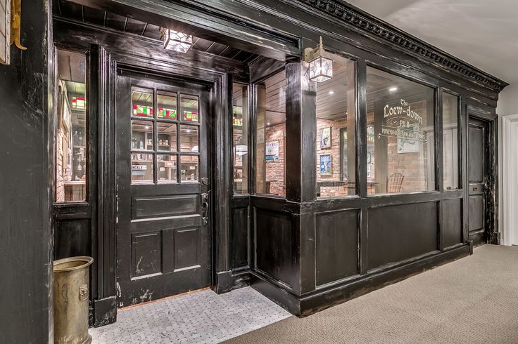 the front entrance to a restaurant with black doors