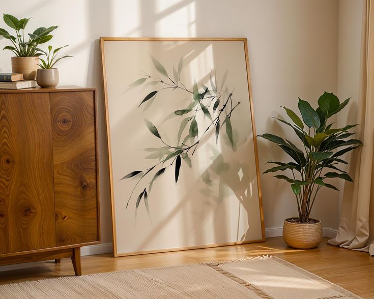 an empty room with two plants in the corner and a framed photograph on the wall