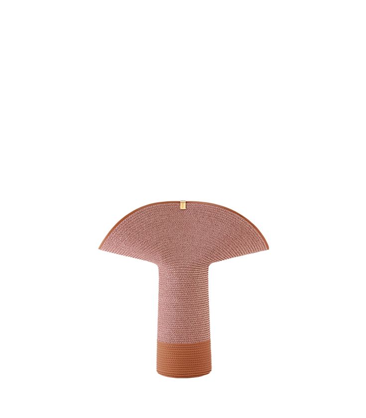 a pink and brown object on a white background