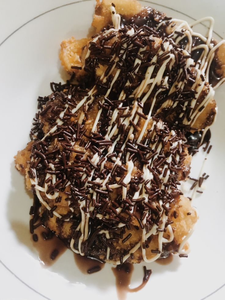 a white plate topped with chocolate covered dessert