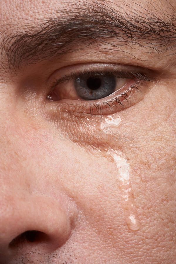 a man's eye with tears on it and his nose is covered in white cream