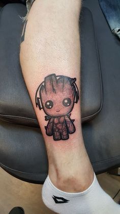 a person with a small tattoo on their arm and leg that has a baby groote in it