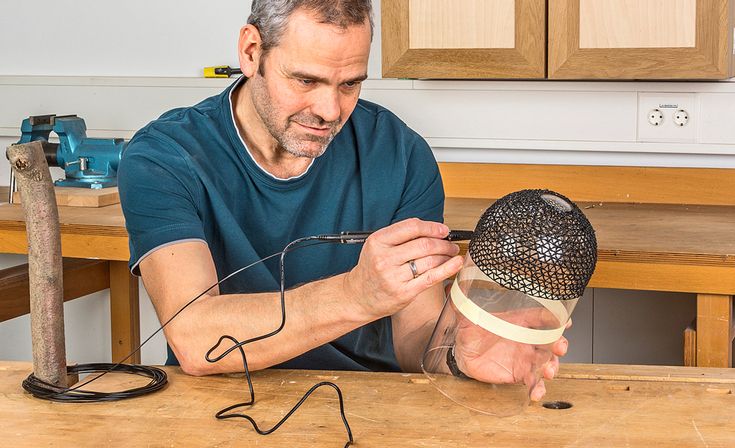 a man is working on some kind of hat