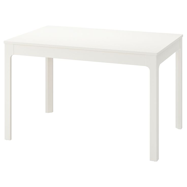 a white table sitting on top of a white floor