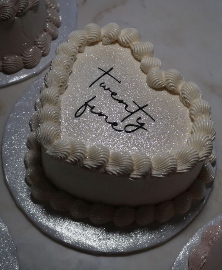 a heart shaped cake with the words thank you written on it in cursive writing