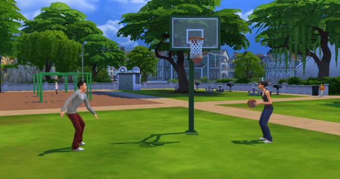 two people are playing basketball in the park