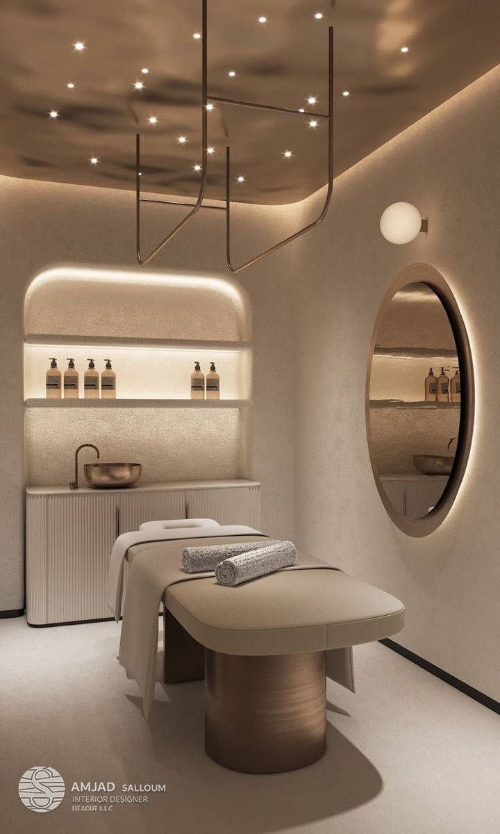 a spa room with an oval mirror above the bathtub and lights on the ceiling