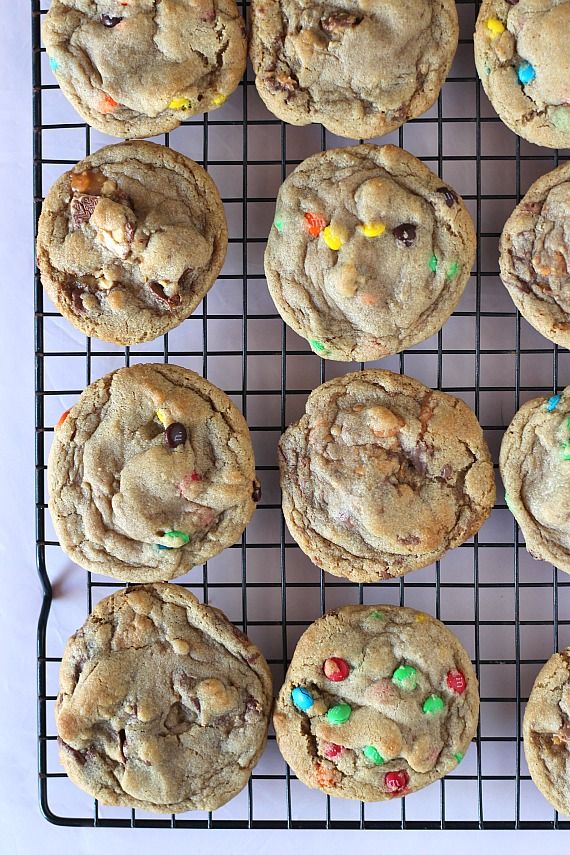 chocolate chip cookies with sprinkles and m & m on a cooling rack