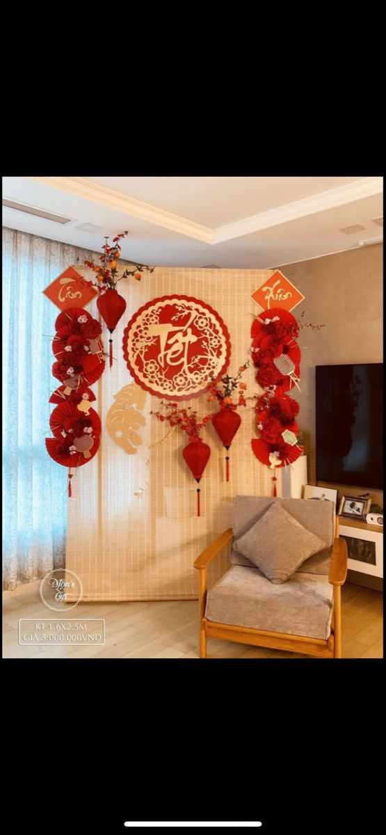 the living room is decorated in red and white with paper decorations on the wall above it