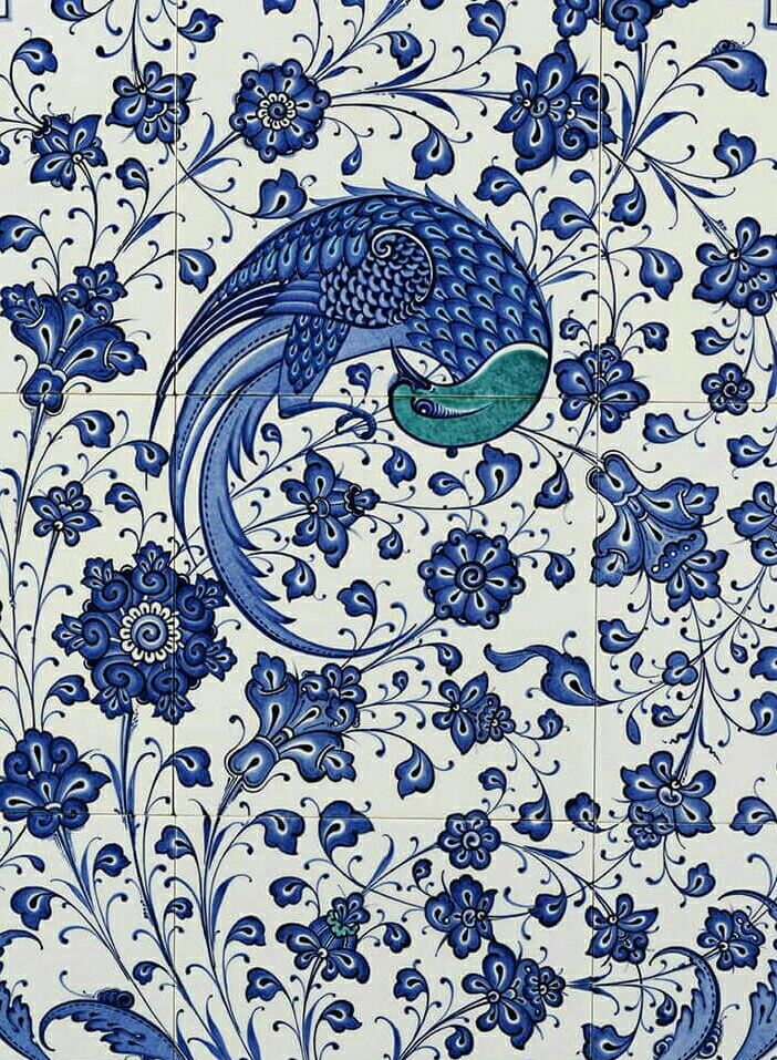 a blue and white tile with an intricate design on the outside, depicting a peacock surrounded by flowers