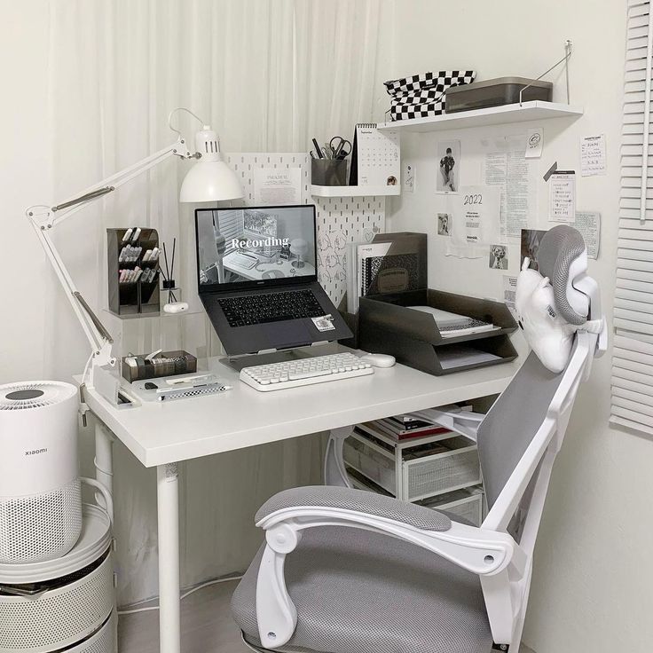 a white desk with a laptop computer sitting on top of it