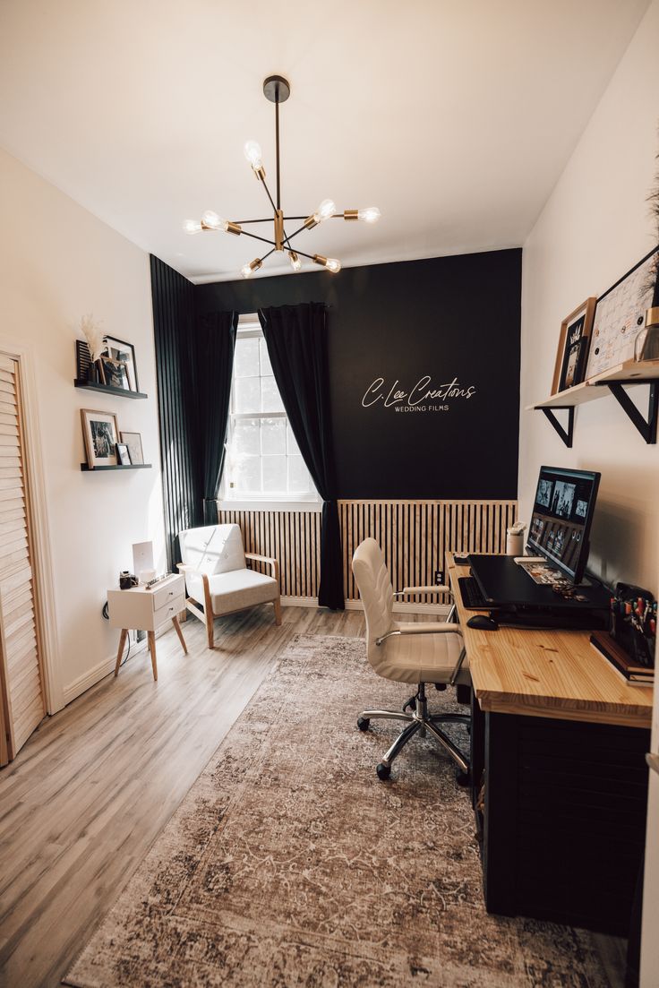 a room with a desk, chair and computer on it in front of a window