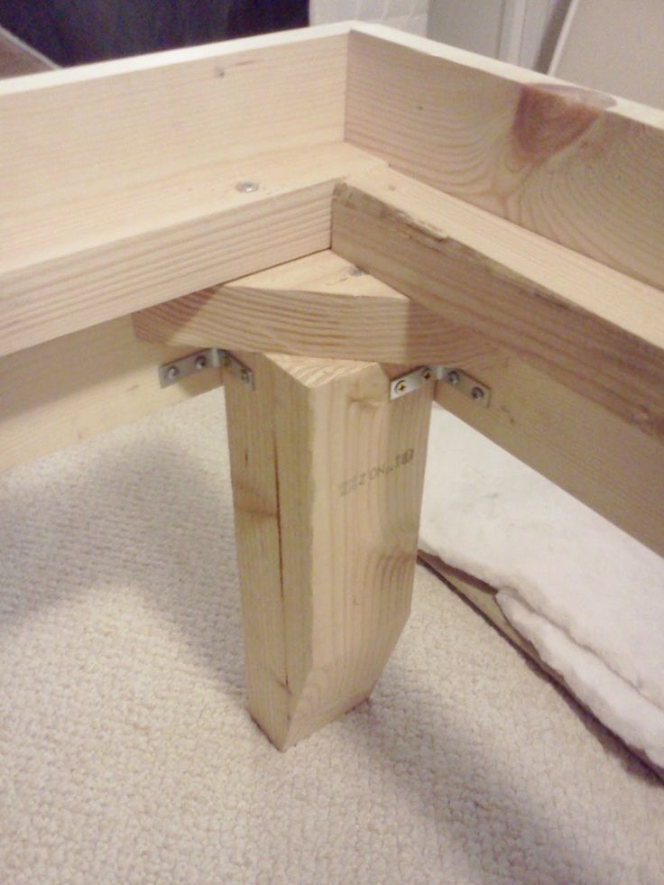 a wooden bench sitting on top of a carpeted floor