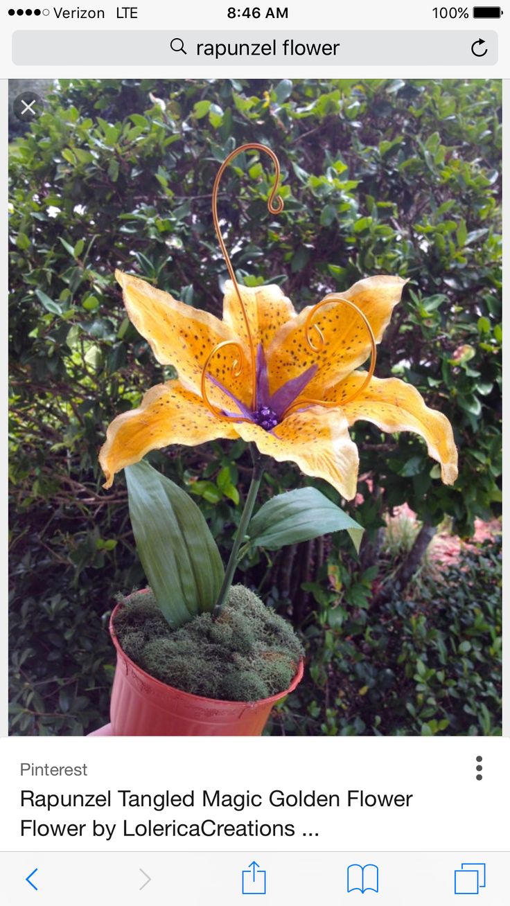 a large yellow flower sitting on top of a lush green forest filled with trees and bushes