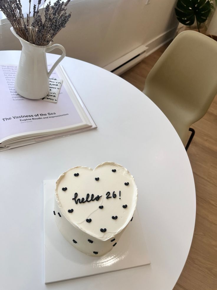 a heart shaped cake sitting on top of a white table