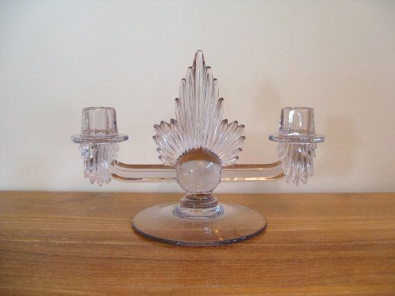 a glass candle holder on a wooden table