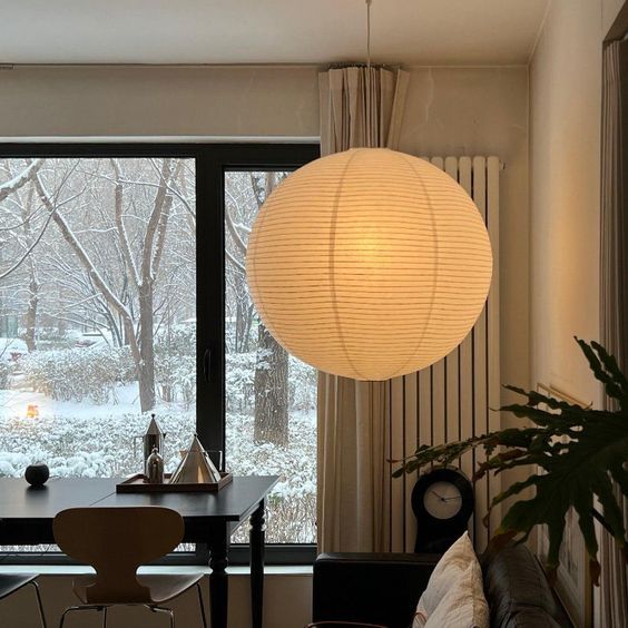 a living room filled with furniture and a large window covered in frosted glass doors