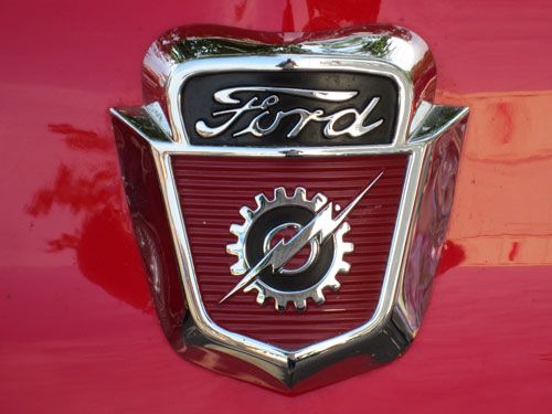 an emblem on the hood of a red car