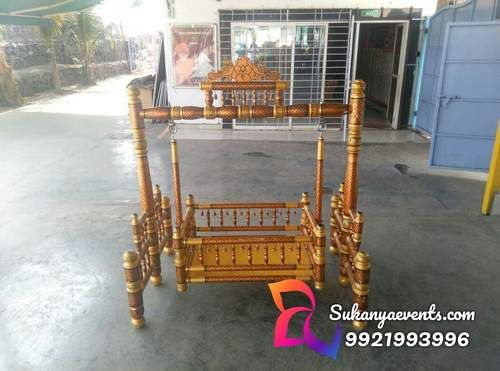 a wooden bed frame sitting in front of a building