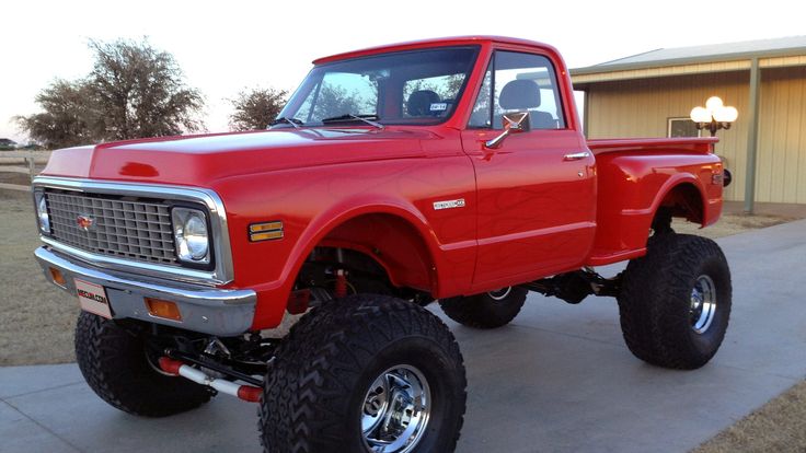 a red truck parked in front of a house