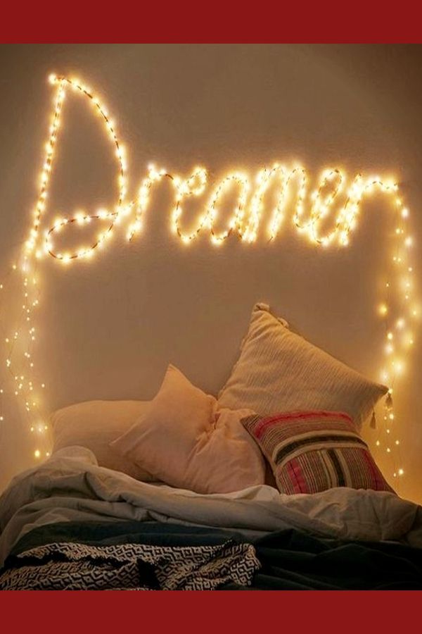 a bed with lights on the headboard above it that says,'dream '