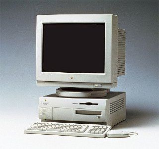 an old computer sitting on top of a desk