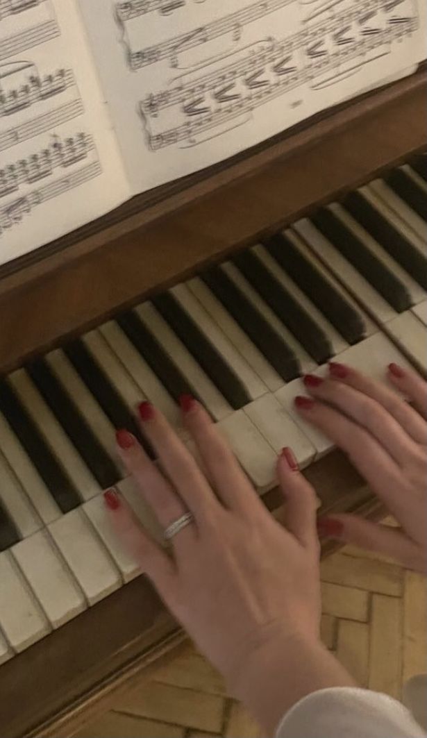 a woman is playing the piano with her hands