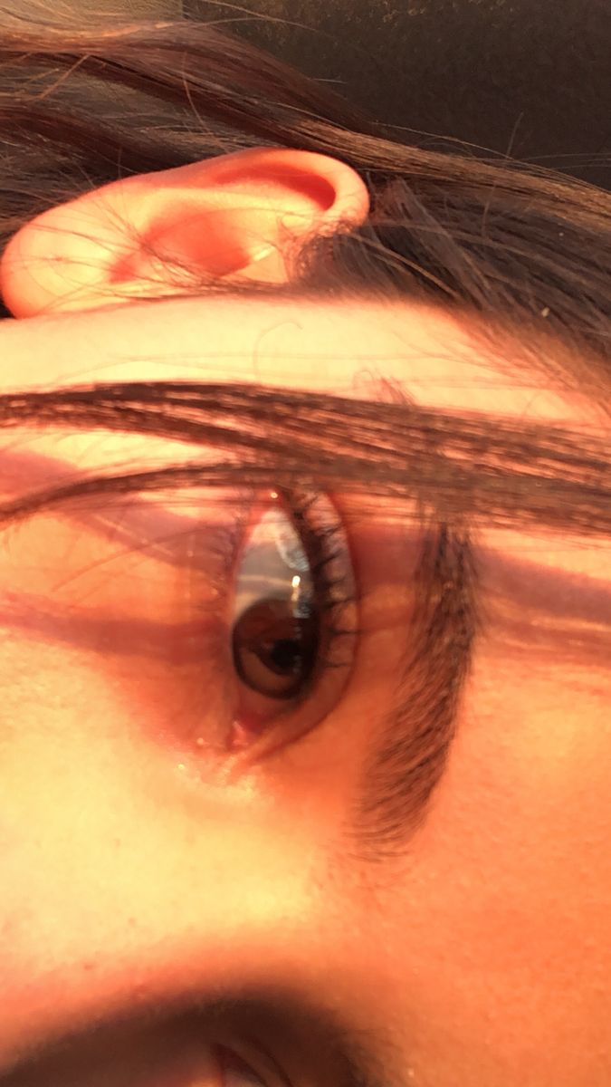 a close up of a person's eye and ear