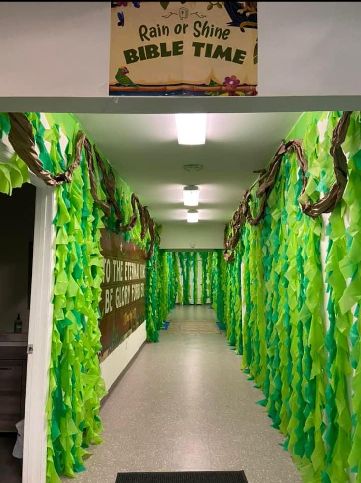 the hallway is decorated with green streamers and ribbon garlands for an entrance to rain or shine bible time